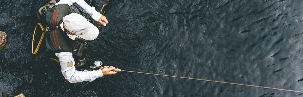 man fishing for trout in creek